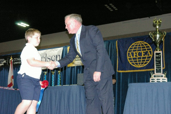 Capt. Slevin recognizes a winner at the February Hillsborough Regional STEM Fair, sponsored by the chapter.